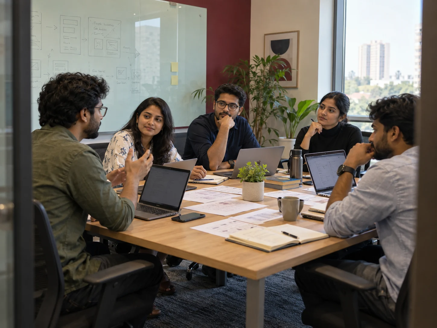 Technology team discussing a product roadmap around a meeting table